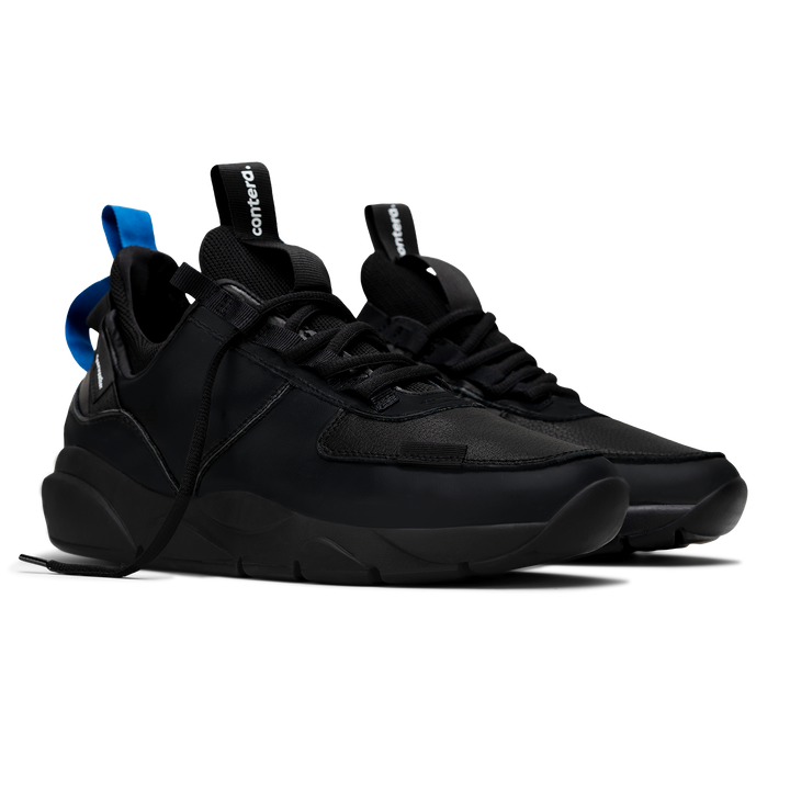 3/4 view,  Contera Black is a runner with Tumbled Black fullgrain leather overlays Black stretch mesh underlays, Royal Blue heel pull molded lace holder, Black eva midsole and Black rubber outsole.